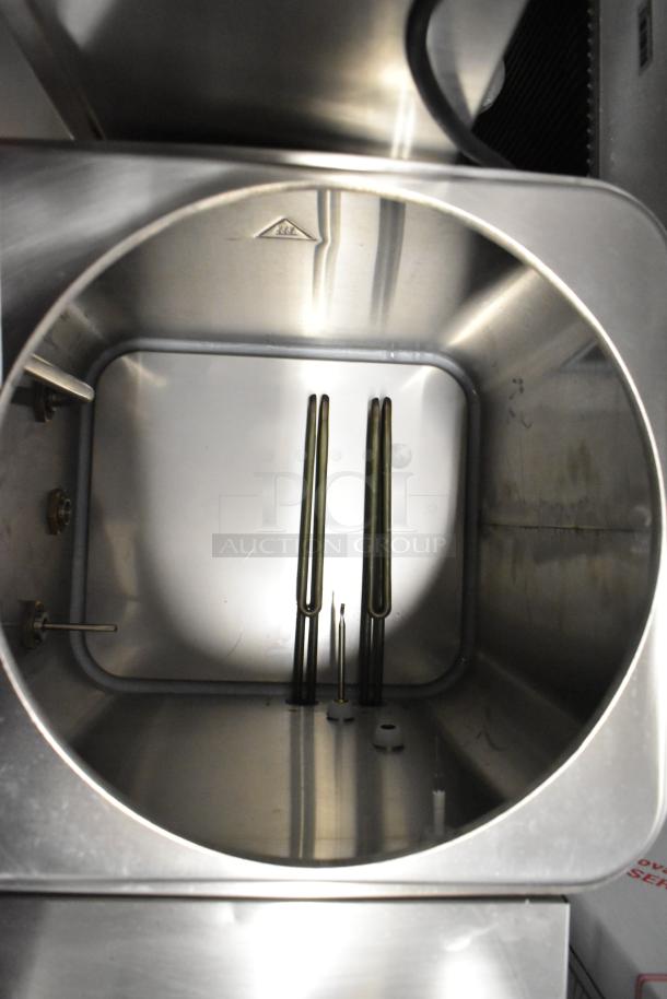 Brand new Avantco 177HWD10D stainless steel 10-gallon hot water dispenser, interior view, shows heating elements.