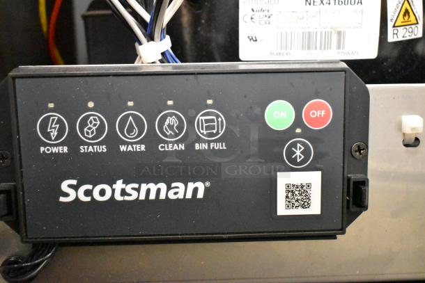 Close-up of control panel on Scotsman MC0530MAX-1A ice machine showing power, status, and cleaning indicators with Scotsman logo.
