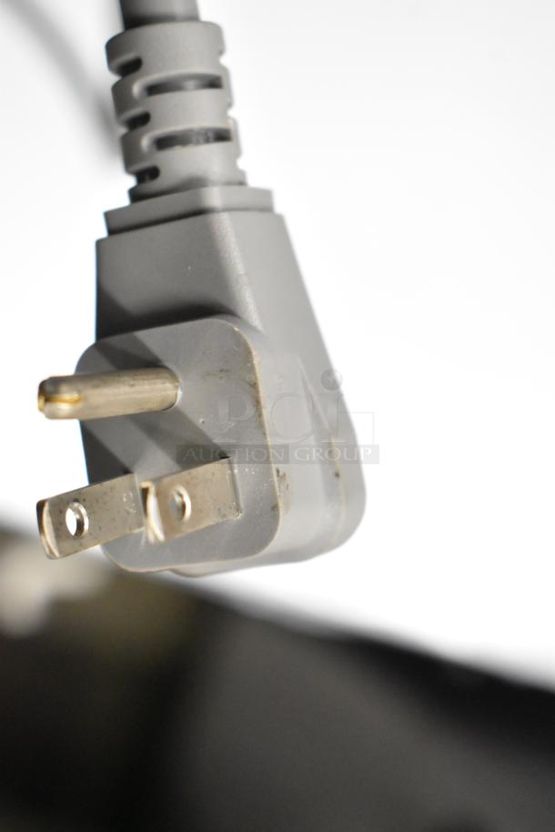 Close-up of a power plug for KoolMore KM-MD-1SS Stainless Steel Microwave Drawer, showcasing the three-prong design.