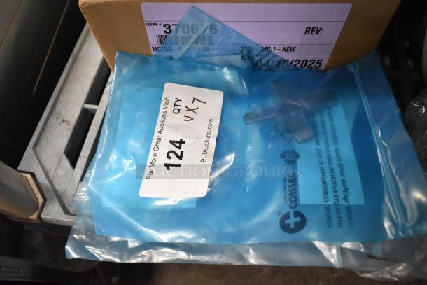 Seven brand new Hobart grinder plates in blue packaging, labeled QTY x7. Brand tags visible, indicating scratch and dent condition.