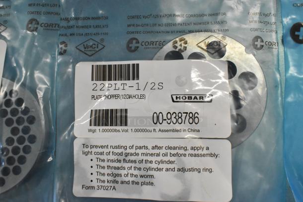 Brand new Hobart grinder plates for meat chopper, model 22PLT-1/2S, in original packaging. Includes corrosion inhibitor and care instructions.