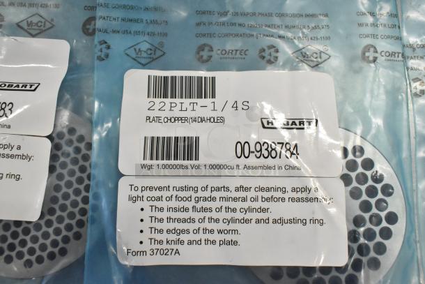 Hobart grinder plates, new condition, in packaging. Item 22PLT-1/4S. Plate chopper with 1/4 inch holes. Weight: 1 lb.