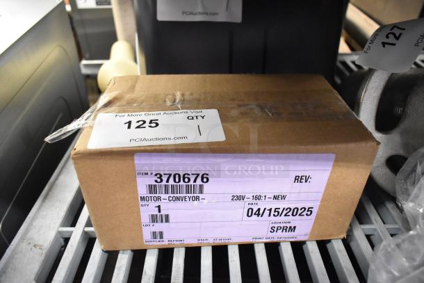 Brand new Lincoln 370676 motor in box, 230V, 50-60Hz, item tag shows minor scratches, dated 04/15/2025.