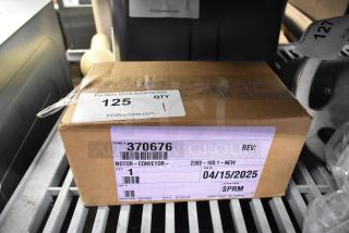 Brand new Lincoln 370676 motor in box, 230V, 50-60Hz, item tag shows minor scratches, dated 04/15/2025.