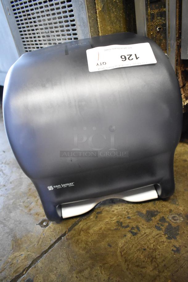 San Jamar poly wall mount paper towel dispenser, brand new with minor scratches and dents, marked "126 QTY".