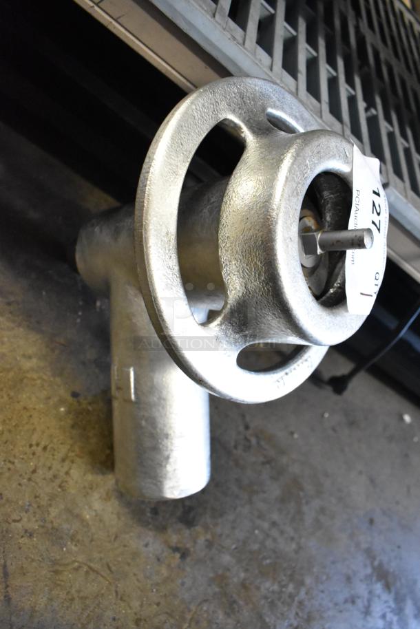 Brand new metal commercial meat grinder attachment, scratch and dent condition, features durable construction. Auction tag visible.