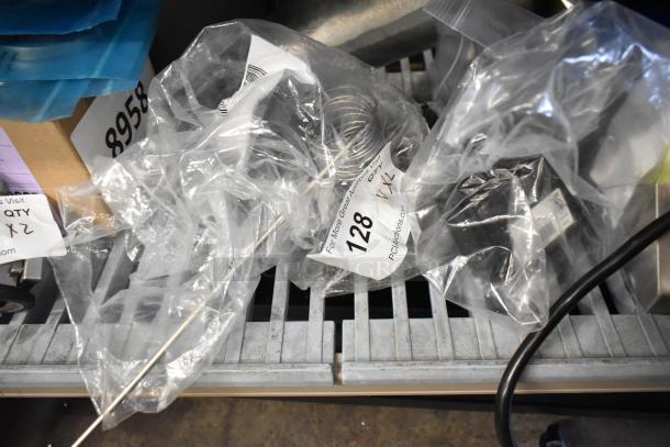 Two brand new scratch and dent control parts in packaging: Southbend HP1181998 Cook Control and Garland 240G03145048 FD Control. Auction tag visible.