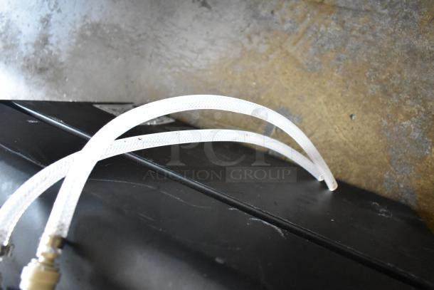 BRAND NEW SCRATCH AND DENT! Fetco DRNX SLM DUO dual tap nitro beverage dispenser, visible hoses, black casing. 120V, 1-phase.