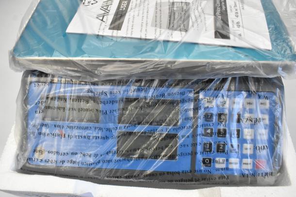 Brand new AvaWeigh 334PCS15 15 lb. digital price computing scale, sealed in packaging, slight scratches and dents visible.