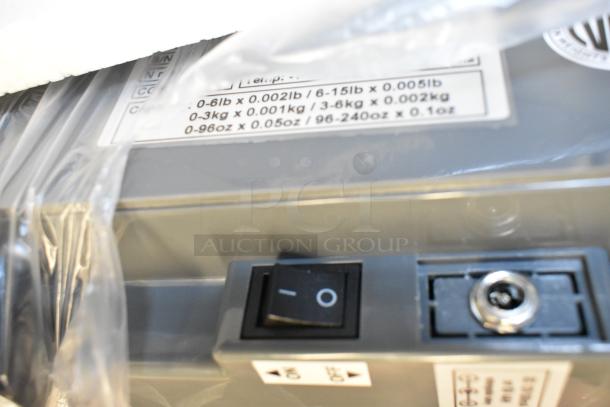 AvaWeigh 334PCS15 15 lb. digital price computing scale, new with minor scratches. Label shows weight capacity and increments.