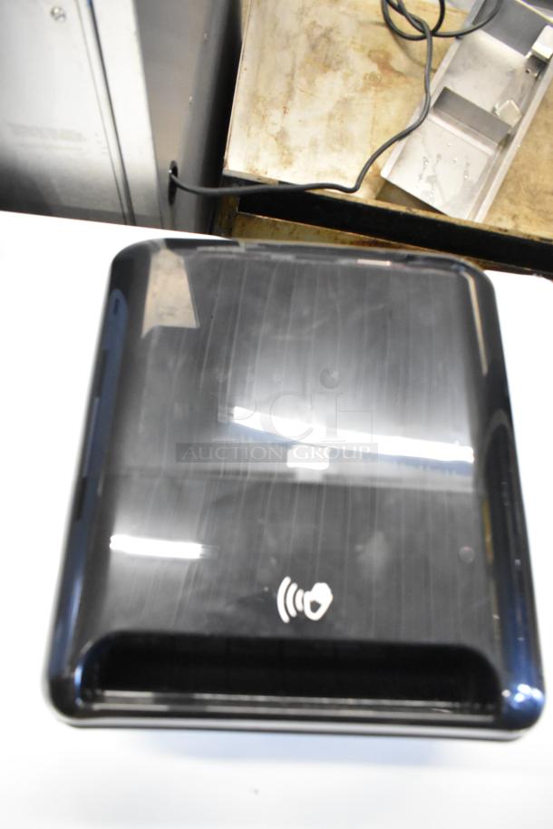 Black Tork Matic® 5511284 automatic hand towel dispenser, new with scratches, wall-mount design, model 7125511284.