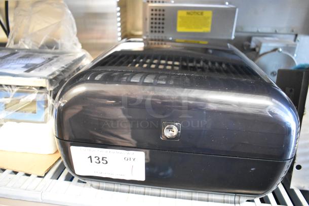 BRAND NEW Tork Matic® 5511284 black wall-mount automatic hand towel dispenser, minor scratches, with visible lock and label.