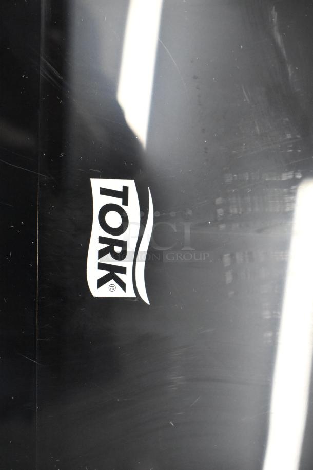 BRAND NEW Tork Matic® 5511284 wall-mount automatic towel dispenser, black with visible scratches, logo featured prominently.