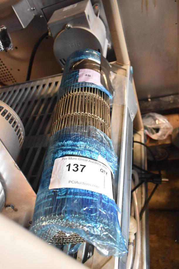 Brand new scratch and dent metal conveyor belt, wrapped in blue packaging, labeled "For More Great Auctions Visit PCIauctions.com 137 QTY".