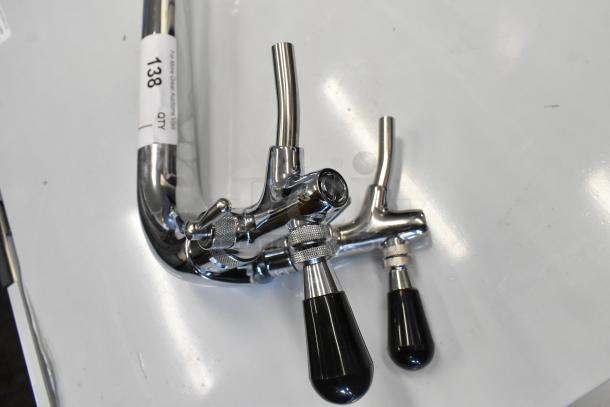 Brand new stainless steel two-tap beer tower with minor scratches, labeled "138," chrome finish, sturdy handles.