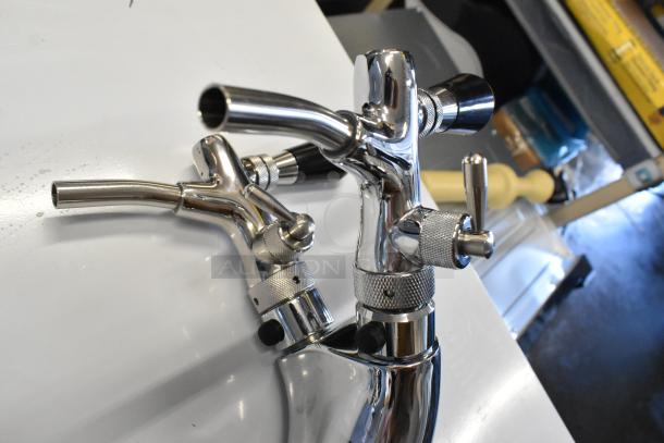 Brand new scratch and dent stainless steel 2 tap beer tower, polished finish, minor aesthetic imperfections visible.