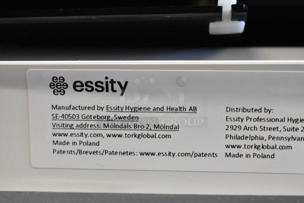 Label on Tork PeakServe dispenser reads Essity, made in Poland, with manufacturer and distributor details in Sweden and USA.