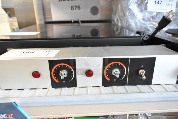Brand new metal heat strip with minor scratches. Features dual knobs, red indicator lights, and control switches.