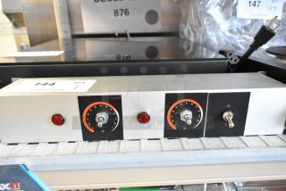 Brand new metal heat strip with minor scratches. Features dual knobs, red indicator lights, and control switches.