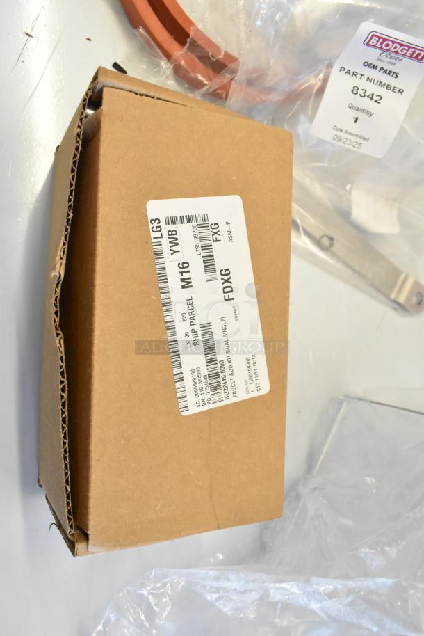 Cardboard box labeled with Bunn Faucet Kit HP224490000, new condition, beside Blodgett Door Guide package.