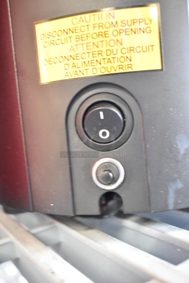 BRAND NEW 2025 Mahlkonig E65T GBS Commercial Espresso Grinder, black, 2.6 lb. capacity. Caution label visible.