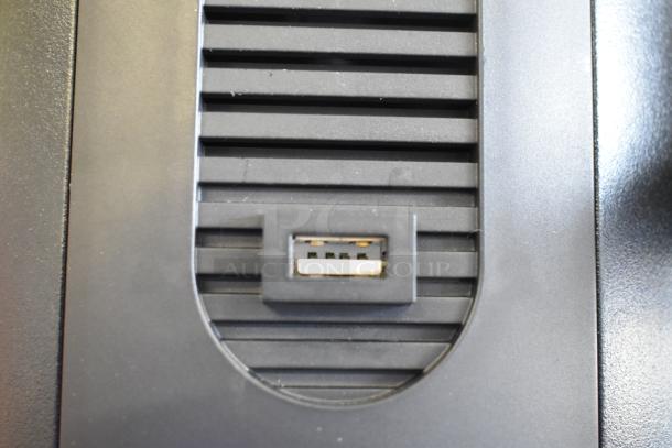 Close-up of the Mahlkonig E65T GBS espresso grinder showing a USB port on its black metal exterior.