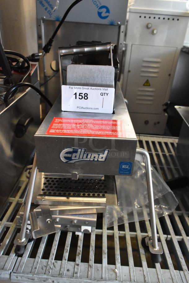 Brand new Edlund 350 electric slicer, 115V, 1 phase. Scratch and dent condition. Edlund logo and NSF label visible.