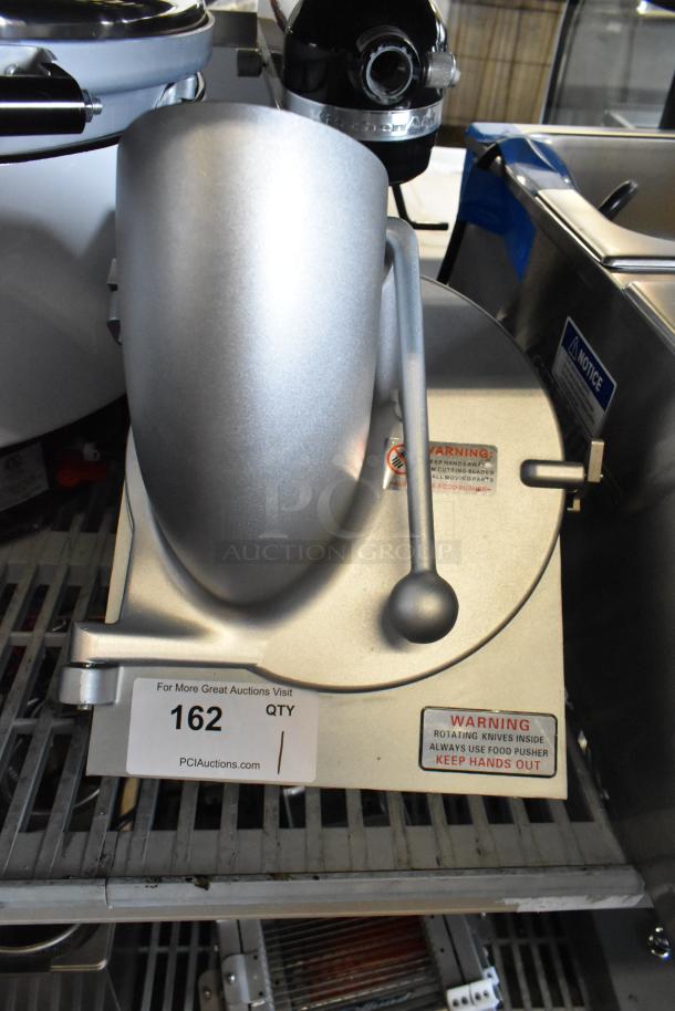 Brand new metal commercial pelican head with grating blade. Visible warning labels; minor scratches, no major dents.