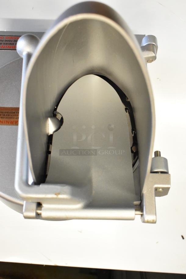 Brand new scratch and dent metal commercial pelican head with grating blade, minor scratches, durable, essential for food processing.