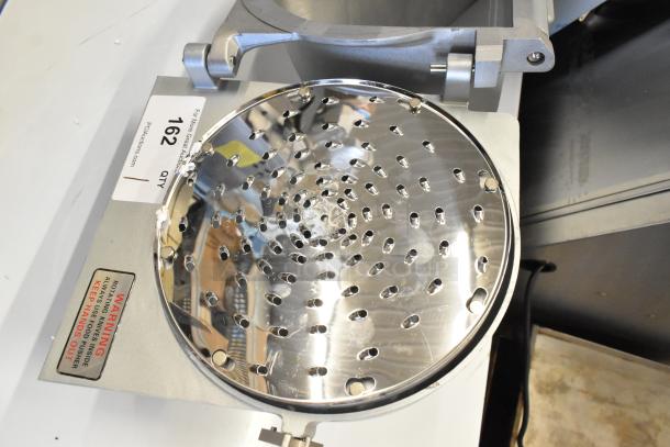 Brand new scratch and dent metal commercial pelican head with grating blade. Features visible grating holes, metal construction, and warning label on base.