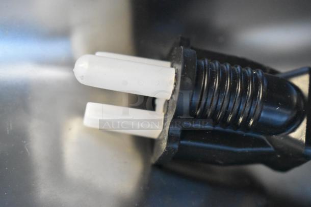 Close-up of Avantco 177W50 food warmer power connection. Features a plastic connector with dual prongs, indicating electric interface.