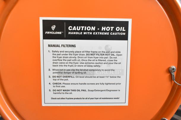 Brand new Fryclone 6.5 Gallon Orange Utility Oil Pail. "Caution - Hot Oil" label with manual filtering instructions visible.
