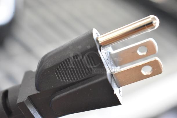 Close-up of a power plug for the AvaMix 928BX2100E Commercial Blender, showing standard prongs and black casing.