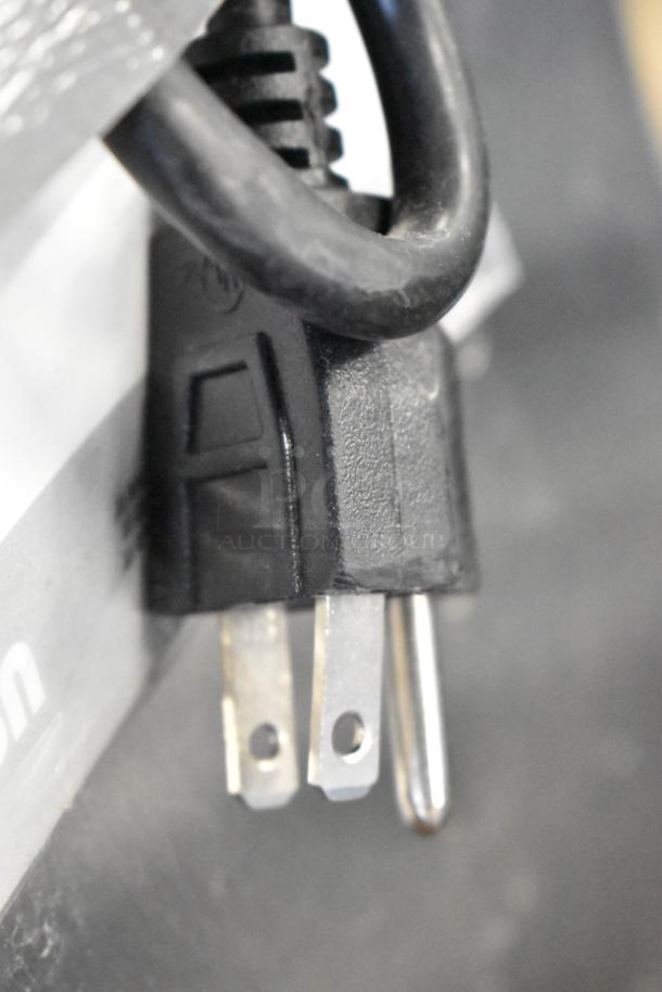Close-up image of a power cord plug for a 2024 ServIt 423HSW2060 stainless steel heated shelf warmer, 120 volts, 1 phase.