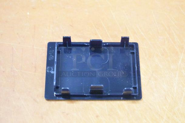 Black plastic component with clips on the edges, possible part for slushy machines or similar equipment. New condition.