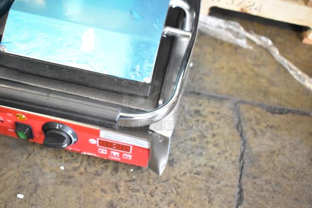 Brand new Avantco 177PG400ST stainless steel panini grill with timer, smooth plates, minor scratches, 19-5/8" x 9-1/8" surface.