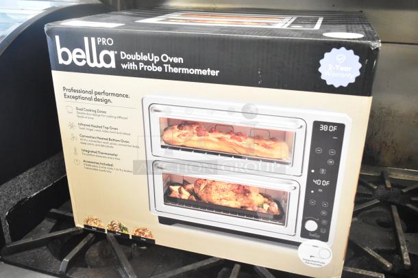 Box of a Bella Pro DoubleUp Oven with Probe Thermometer, scratch and dent condition. Features dual cooking zones, 2-year warranty.