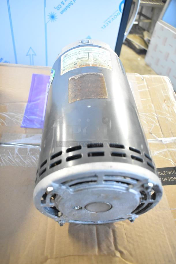 US Motors condenser fan motor, industrial-grade, used condition. Labels indicate specifications and model details.