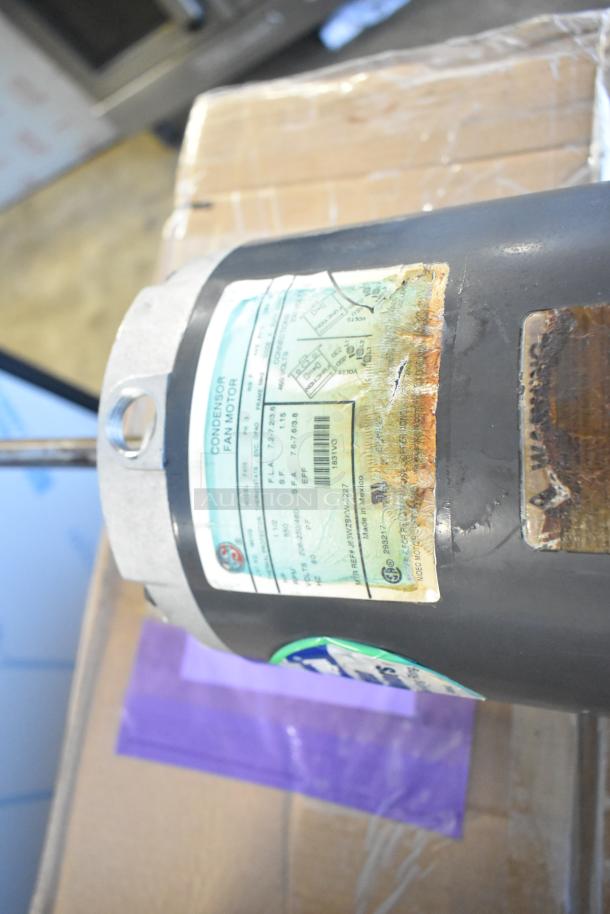 US Motors Condenser Fan Motor, visible label with specs, used condition, on cardboard. Auction for pair of motors.
