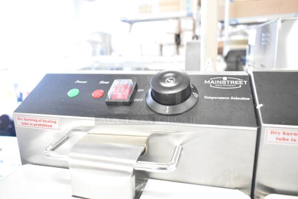Brand new Mainstreet 177F20E stainless steel dual tank electric fryer, 110V, controls and safety labels visible.