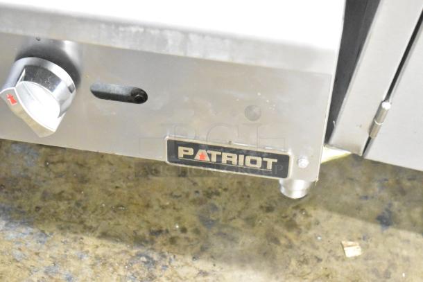 Patriot stainless steel gas flat top griddle with chrome knob and manufacturer's logo. Ideal for commercial use.