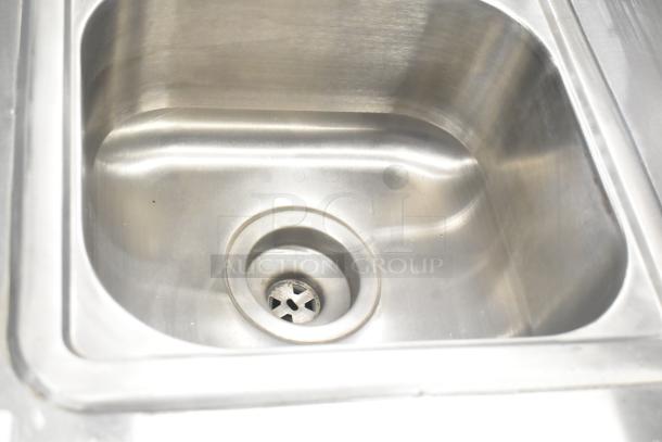 QualServ stainless steel commercial portable sink, visible drain. Mounted on commercial casters. 120V, 1 Phase. Excellent condition.