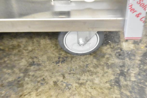 QualServ stainless steel commercial portable sink on caster, 120V, scratch and dent, new condition, visible wheel detail.