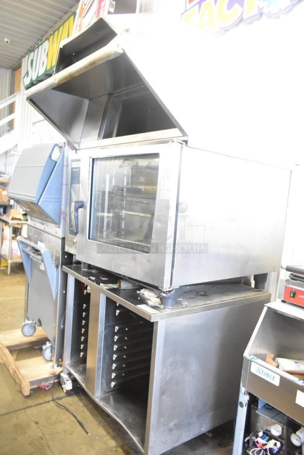 2019 Rational SCC WE 62 stainless steel commercial combi convection oven with UltraVent Plus hood on a double pan rack stand. Door issue noted. 480V, 3 phase.