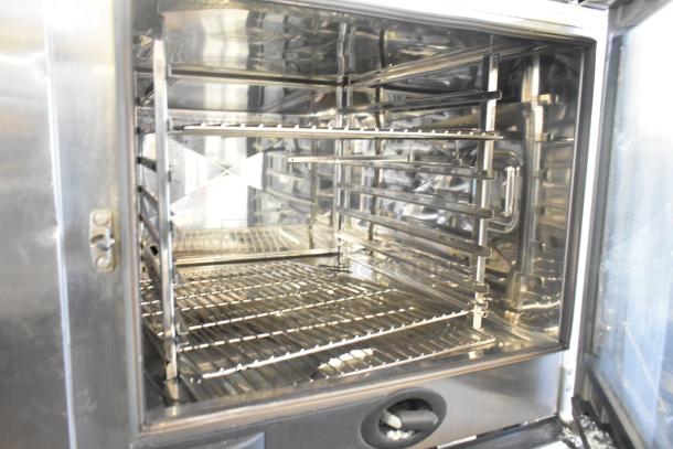 2019 Rational SCC WE 62 Combi Convection Oven, stainless steel, UltraVent Plus hood, door faulty, on double pan rack stand.