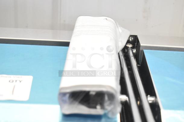 Brand new Avantco 177PG400 stainless steel dual panini grill with grooved plates, showing scratch and dent condition, packaged.