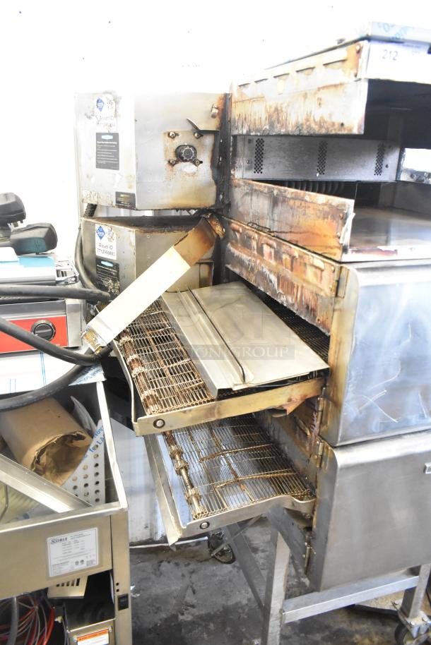 Turbochef HhC2020 stainless steel conveyor oven, commercial casters, some wear, 208/240V, 3 phase, includes shown parts.