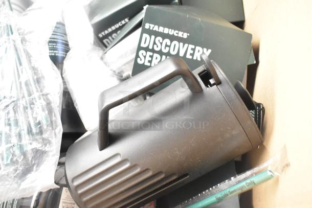 Lot of Starbucks items including Discovery Series boxes, black pitcher, wrapped straws, in used condition.