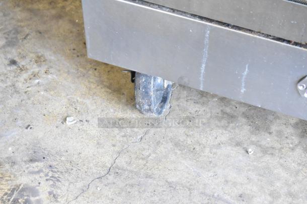 Southbend SL Series stainless steel convection oven on caster, partial view showing wheel and lower panel.