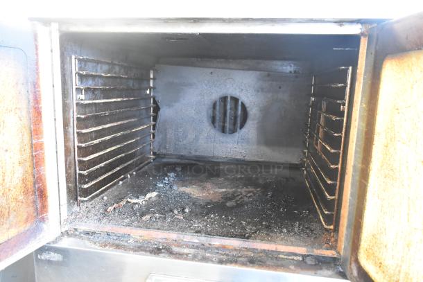 Southbend SL Series stainless steel convection oven interior, featuring multiple racks. Moderate wear. Thermostatic controls, casters.